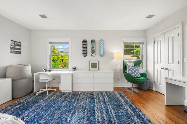 a living room with furniture a flat screen tv and a table