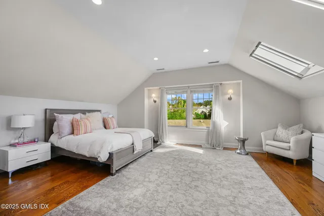 a spacious bedroom with a bed and a large window