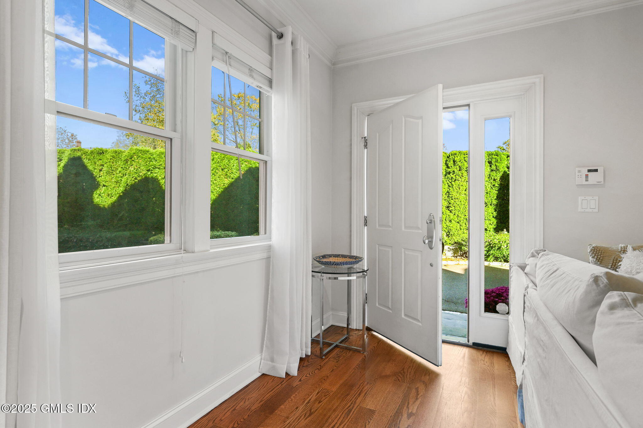 25 Le Grande Avenue, Unit B Greenwich, CT 06830 - Photo 2 of 37 a view of a bedroom with a window and wooden floor