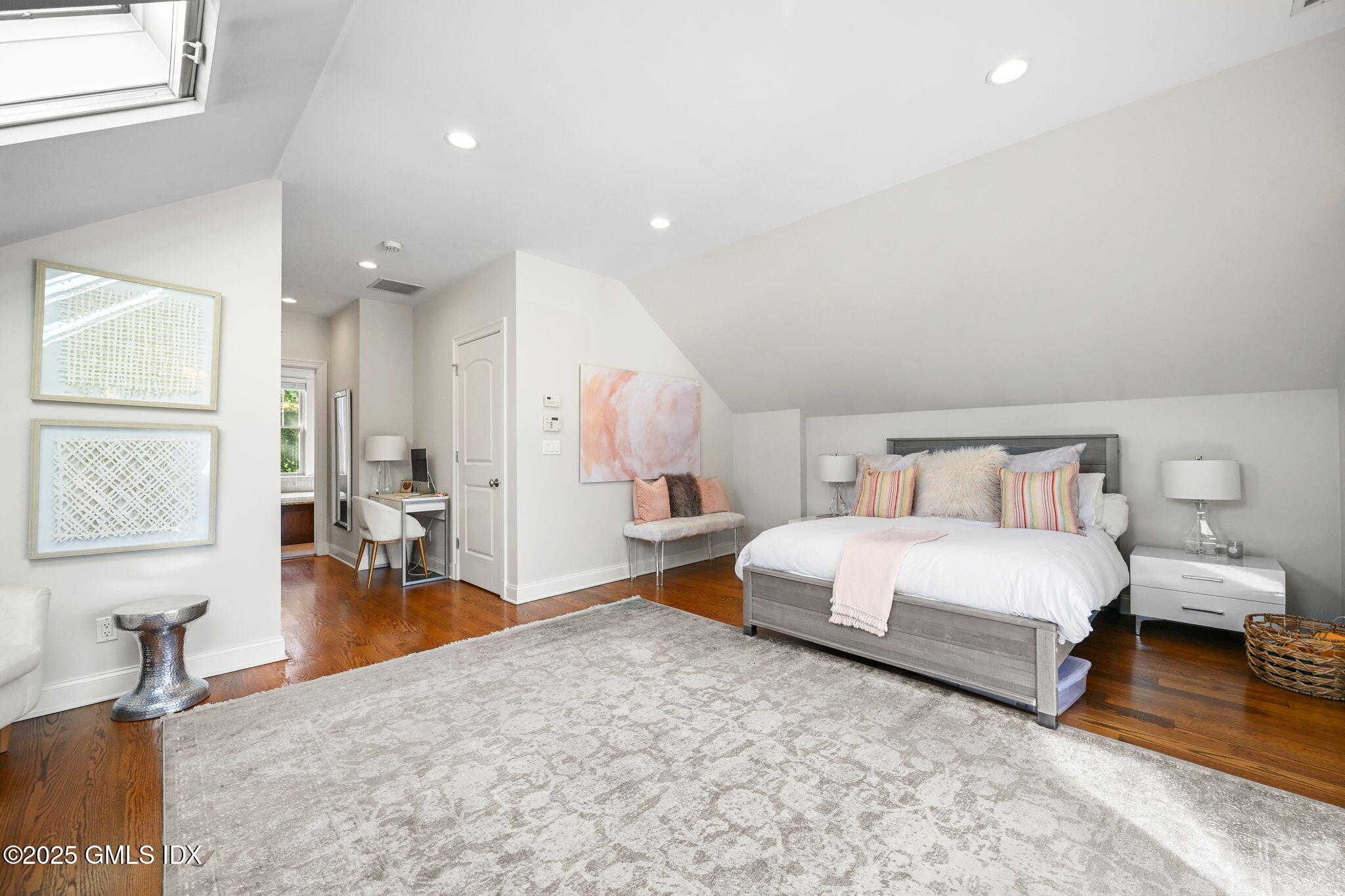 25 Le Grande Avenue, Unit B Greenwich, CT 06830 - Photo 22 of 37 a spacious bedroom with a bed and wooden floor