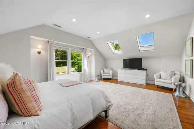 a view of a bathroom with a sink mirror and window
