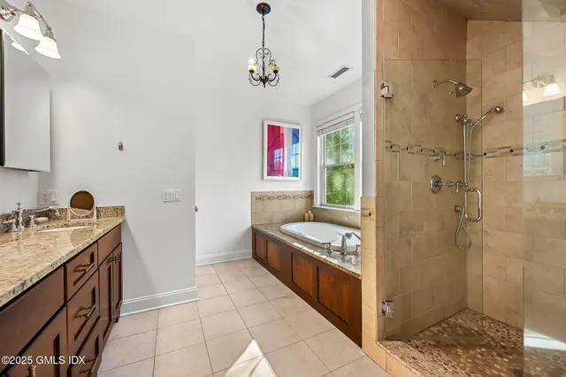 a bedroom with two beds and a chandelier