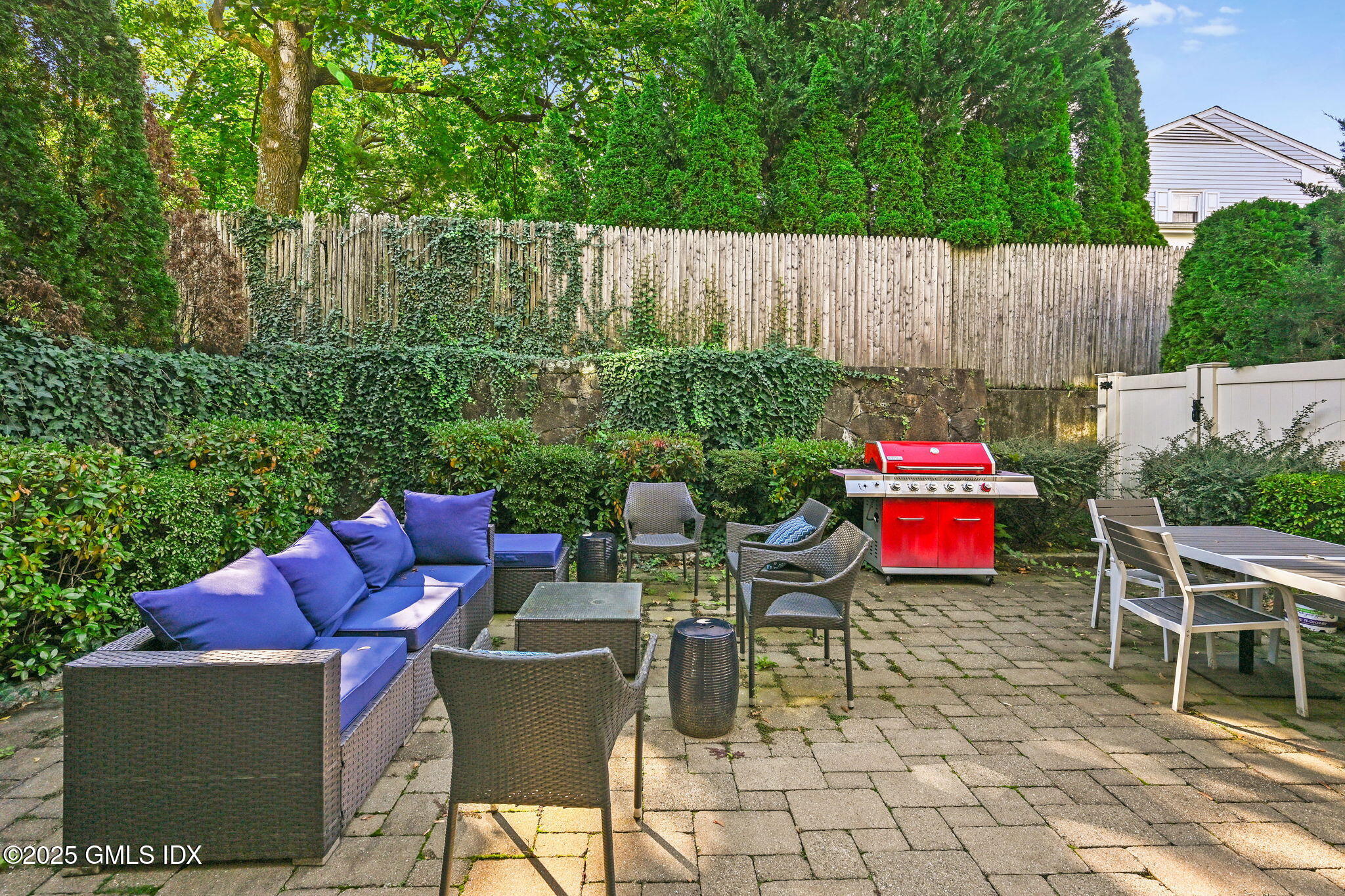 25 Le Grande Avenue, Unit B Greenwich, CT 06830 - Photo 30 of 37 a view of outdoor dining space with a table and chairs