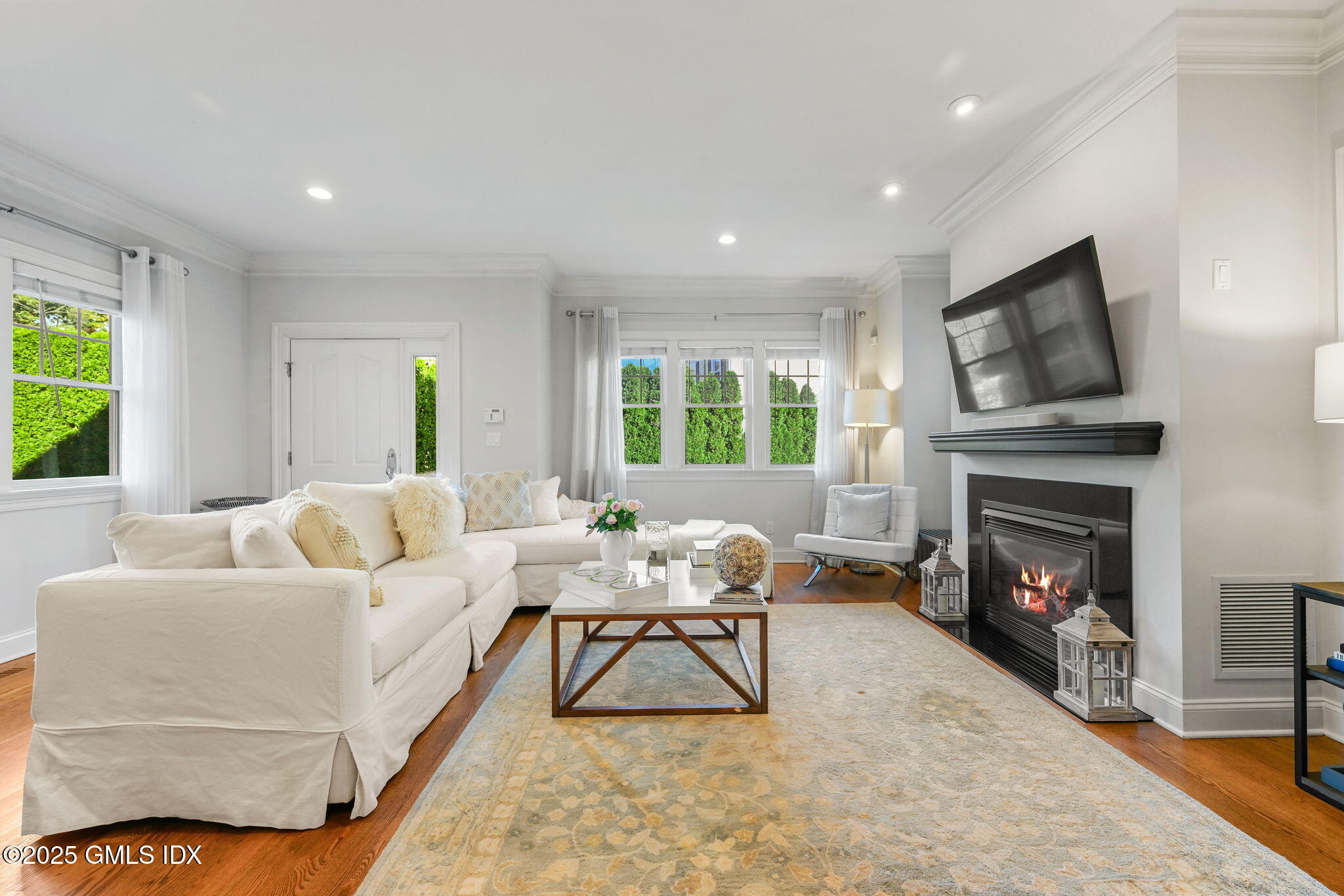 25 Le Grande Avenue, Unit B Greenwich, CT 06830 - Photo 3 of 37 a living room with furniture and a fireplace