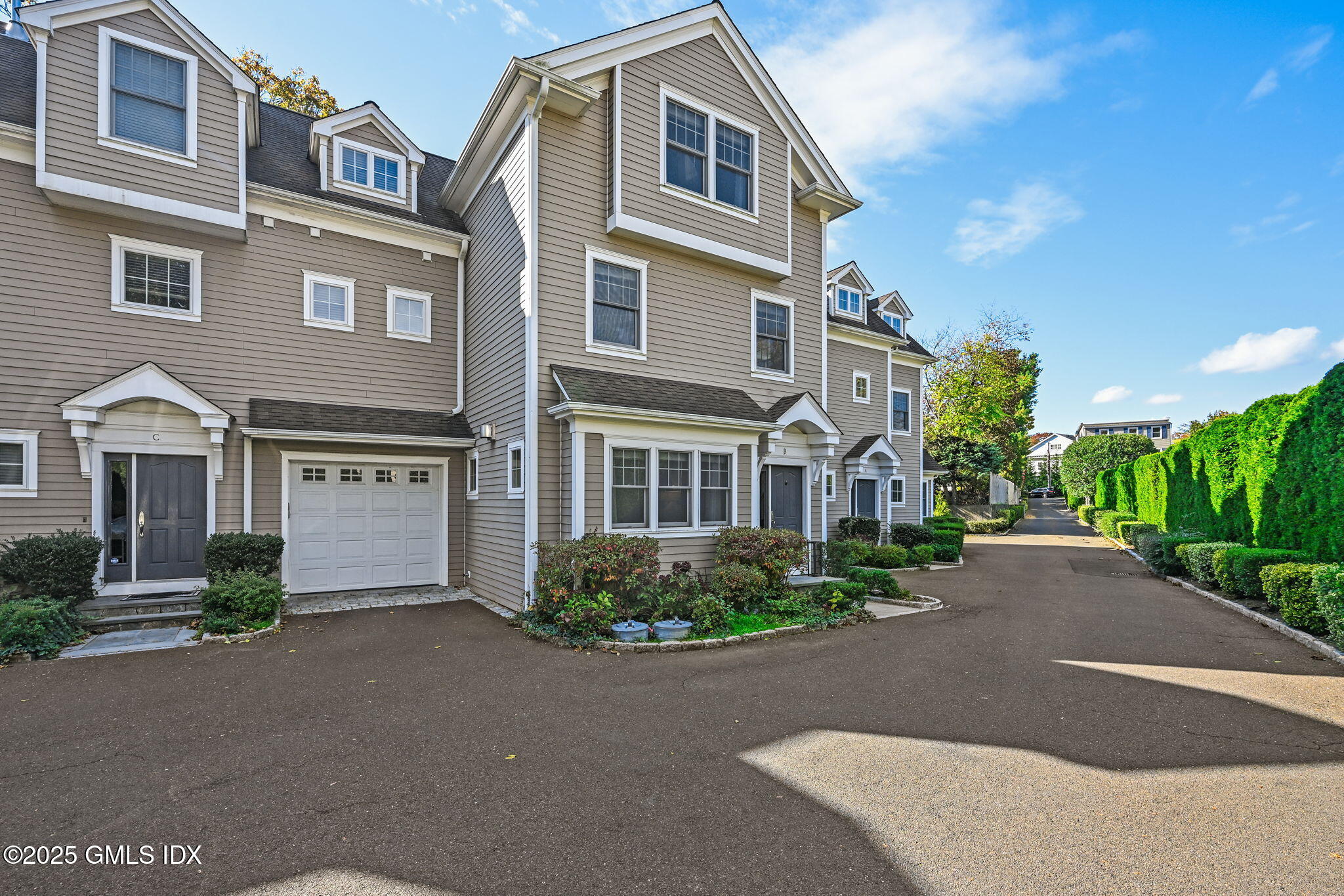 25 Le Grande Avenue, Unit B Greenwich, CT 06830 - Photo 32 of 37 a front view of a house with yard and parking