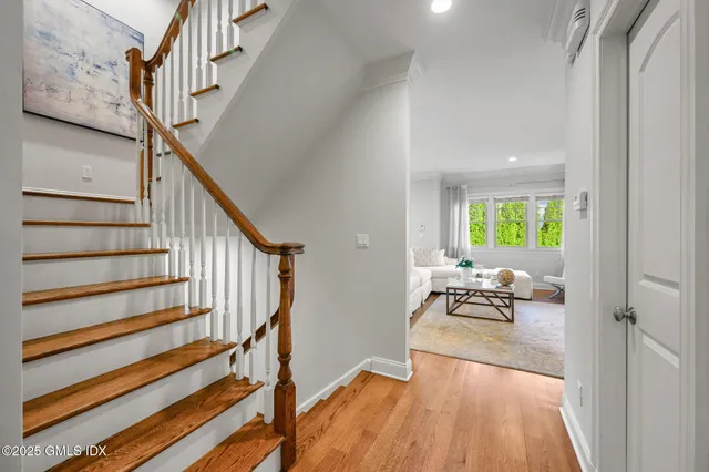 a view of entryway and hall with wooden floor