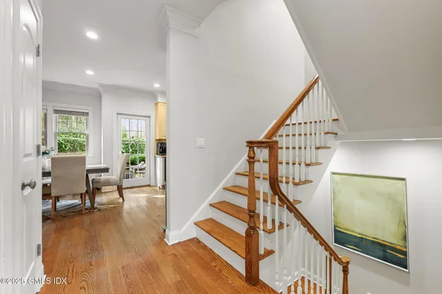 a view of entryway with wooden floor and stairs