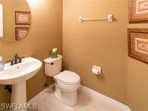 a bathroom with a sink toilet and a mirror