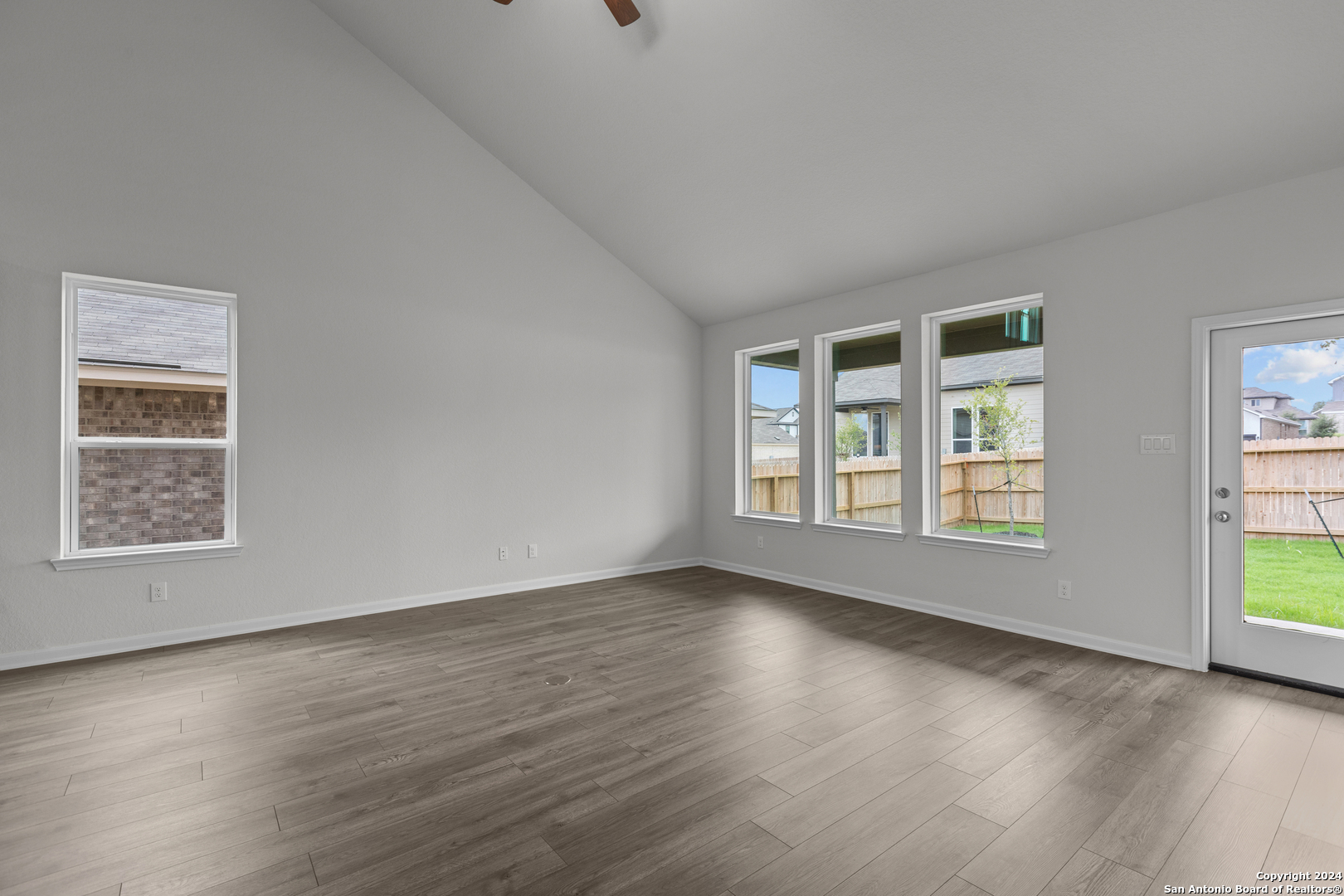 10515 Briceway Bay Helotes, TX 78254 - Photo 4 of 15 a view of an empty room with wooden floor and a window