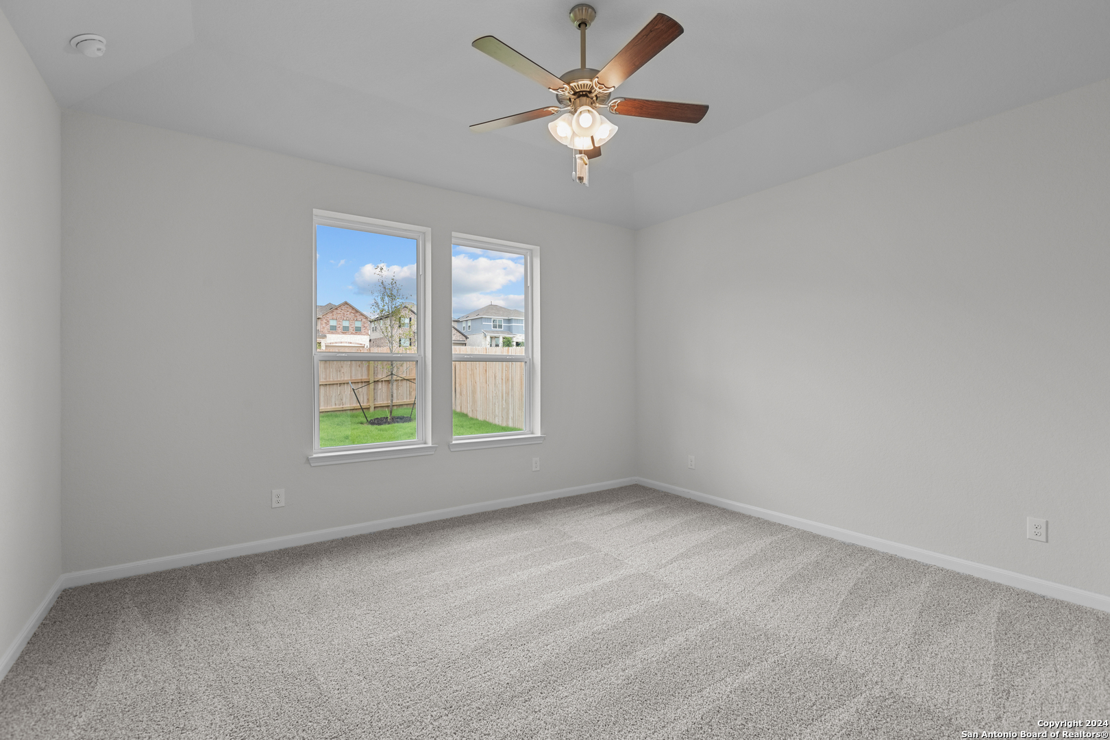 10515 Briceway Bay Helotes, TX 78254 - Photo 5 of 15 an empty room with windows and fan