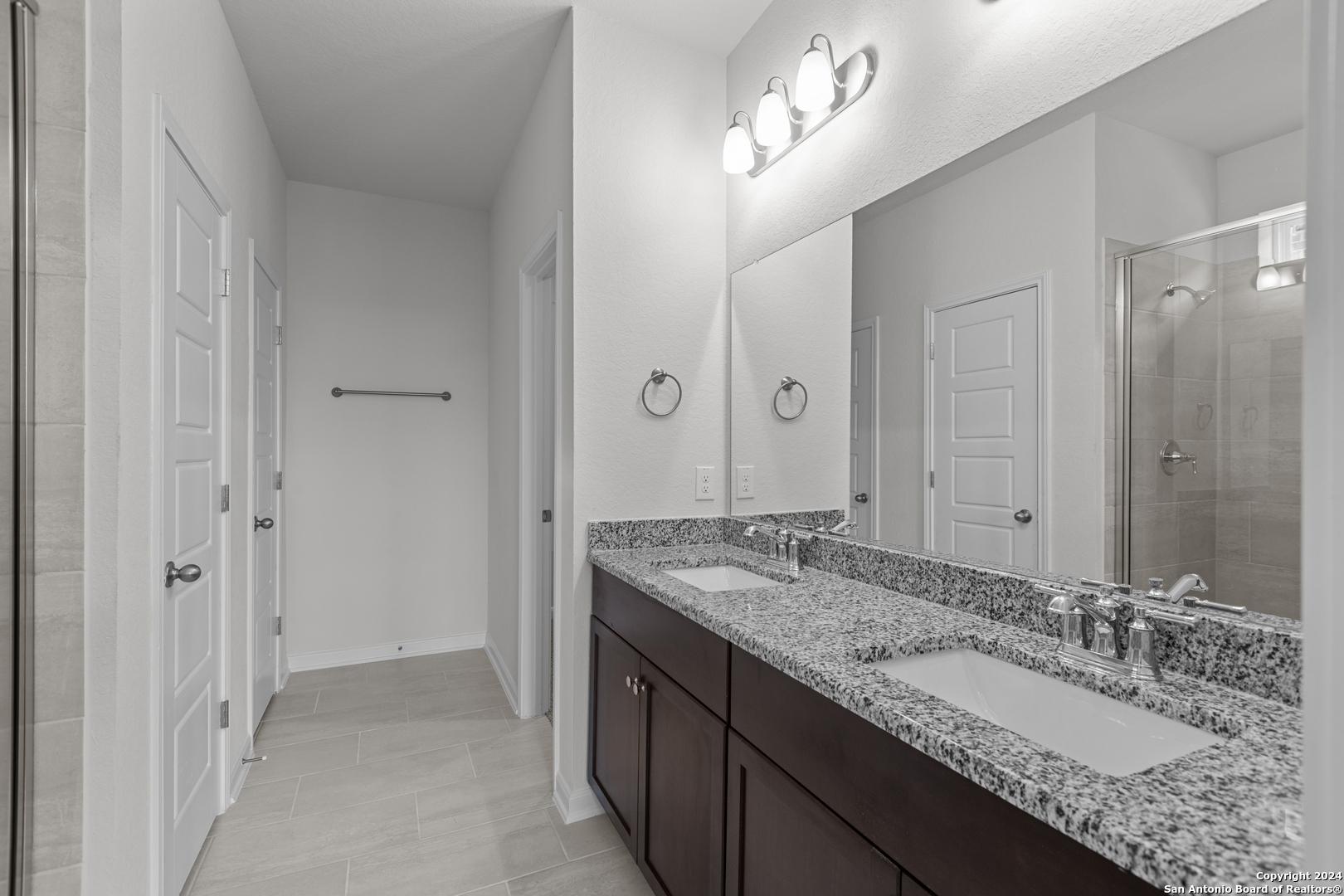 10515 Briceway Bay Helotes, TX 78254 - Photo 6 of 15 a bathroom with a granite countertop double vanity sink and a mirror