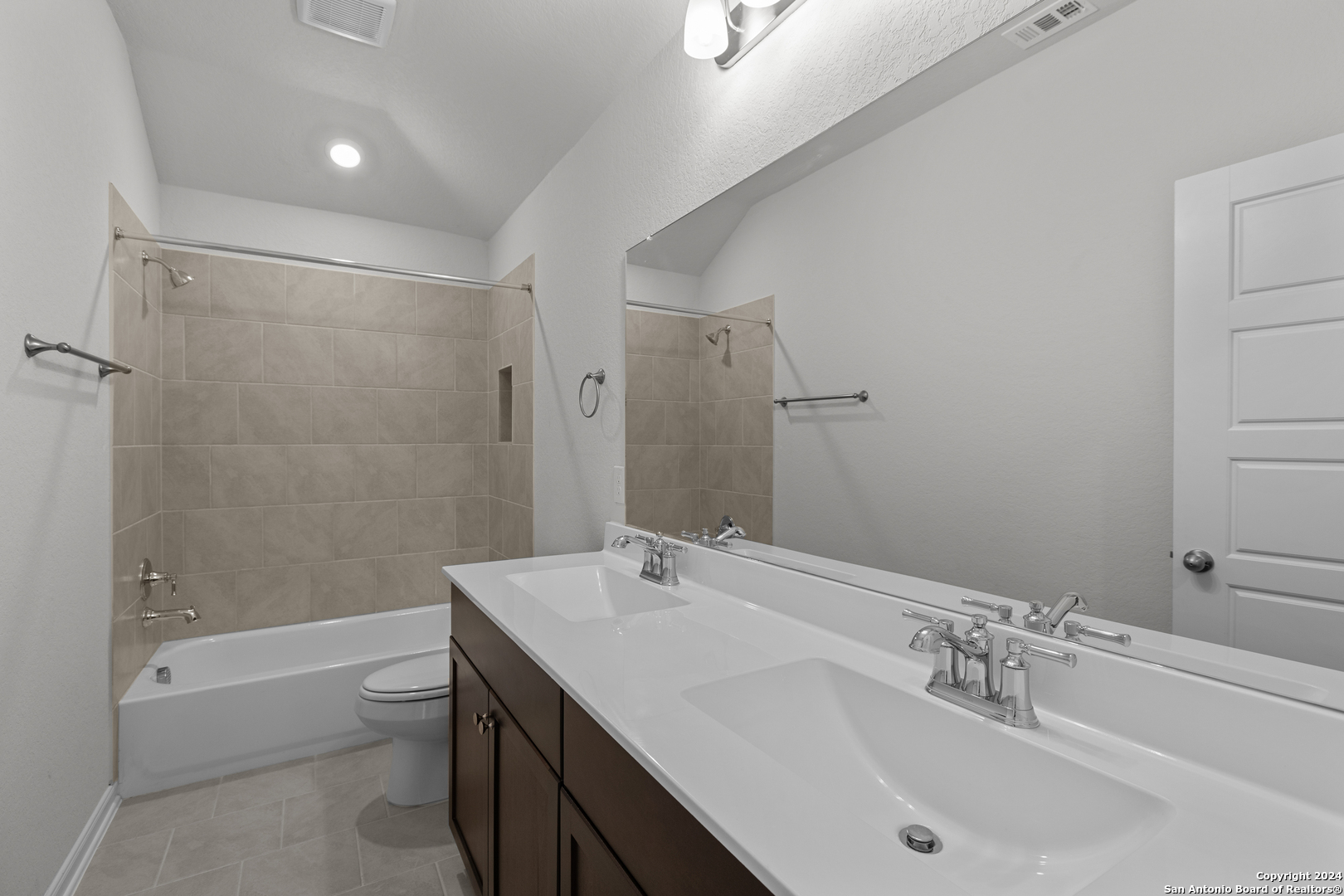 10515 Briceway Bay Helotes, TX 78254 - Photo 10 of 15 a bathroom with a bathtub shower sink vanity and toilet