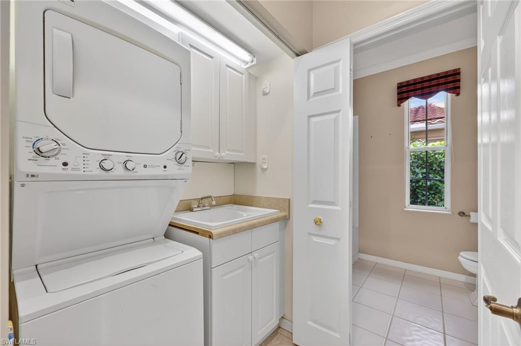 8534 Chase Preserve Drive Naples, FL 34113 - Photo 12 of 44 Laundry area featuring stacked washer and dryer