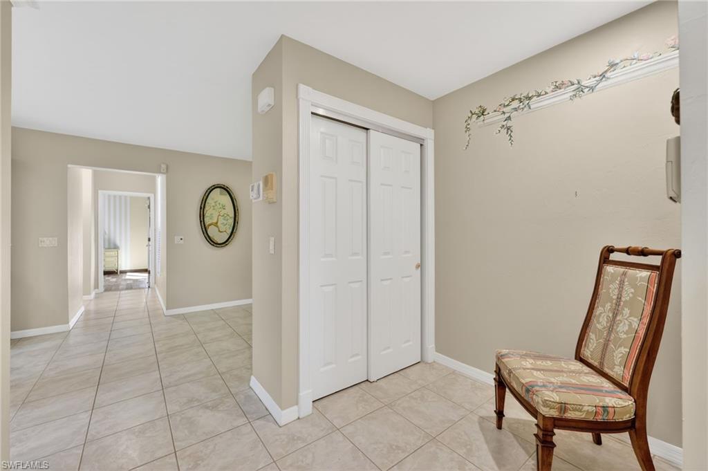 8534 Chase Preserve Drive Naples, FL 34113 - Photo 18 of 44 Corridor to Pantry and storage space with and light tile floors