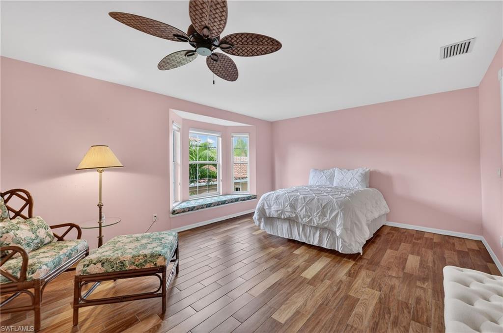 8534 Chase Preserve Drive Naples, FL 34113 - Photo 28 of 44 Bedroom with wood-look tile finished floors and ceiling fan