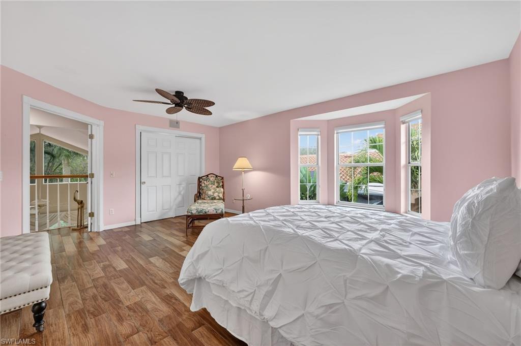 8534 Chase Preserve Drive Naples, FL 34113 - Photo 29 of 44 Bedroom featuring wood-look tile finished floors, a ceiling fan, and a closet
