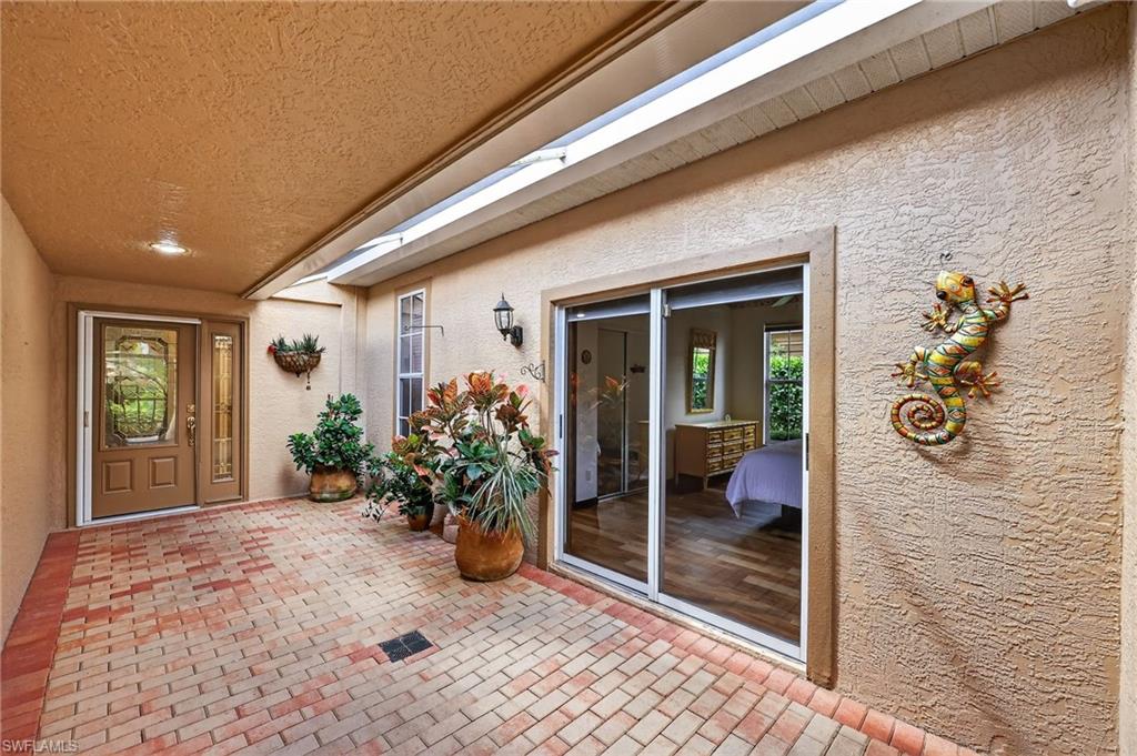 8534 Chase Preserve Drive Naples, FL 34113 - Photo 3 of 44 Courtyard to property featuring stucco siding and a patio