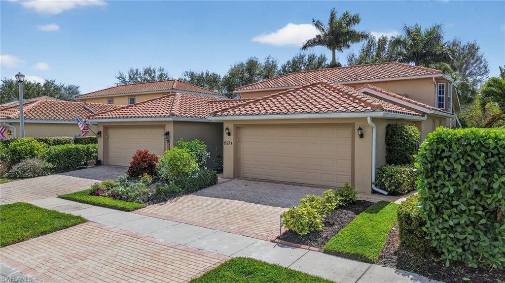 8534 Chase Preserve Drive Naples, FL 34113 - Photo 36 of 44 Mediterranean / spanish house featuring stucco siding, a garage, decorative driveway, and a tile roof