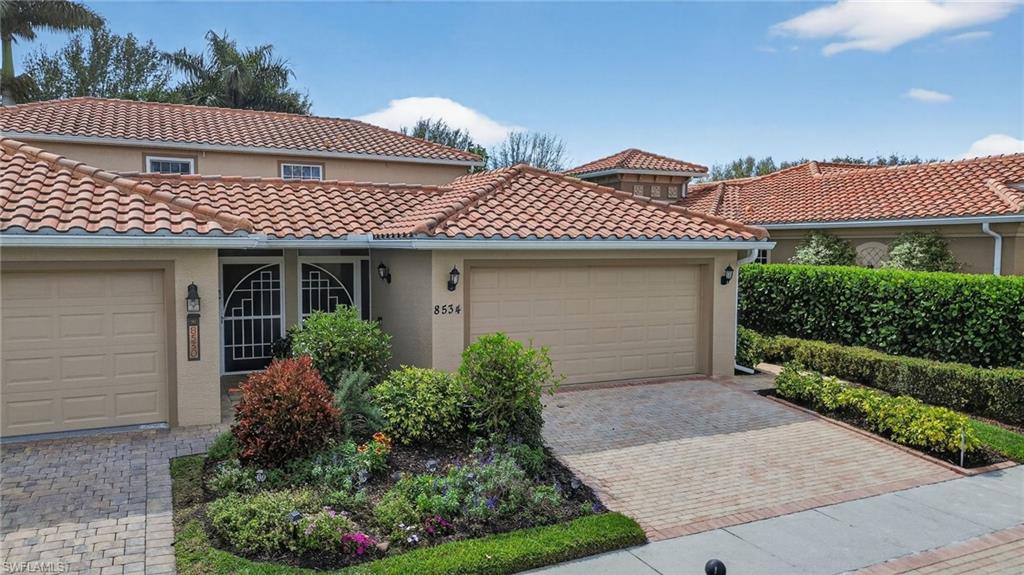 8534 Chase Preserve Drive Naples, FL 34113 - Photo 37 of 44 Mediterranean / spanish-style home featuring stucco siding, a tile roof, a garage, and driveway