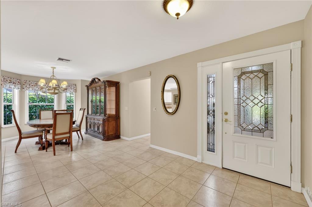 8534 Chase Preserve Drive Naples, FL 34113 - Photo 4 of 44 Foyer with hanging lights and light tile flooring