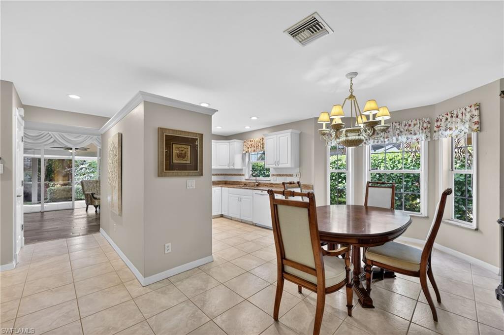 8534 Chase Preserve Drive Naples, FL 34113 - Photo 5 of 44 Dining room with suspended lighting, healthy amount of natural light, and light tile floors