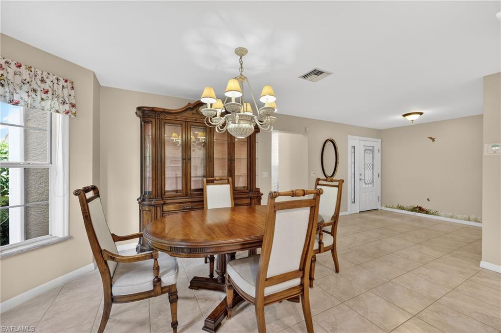 8534 Chase Preserve Drive Naples, FL 34113 - Photo 6 of 44 Dining space featuring suspended lighting and light tile floors
