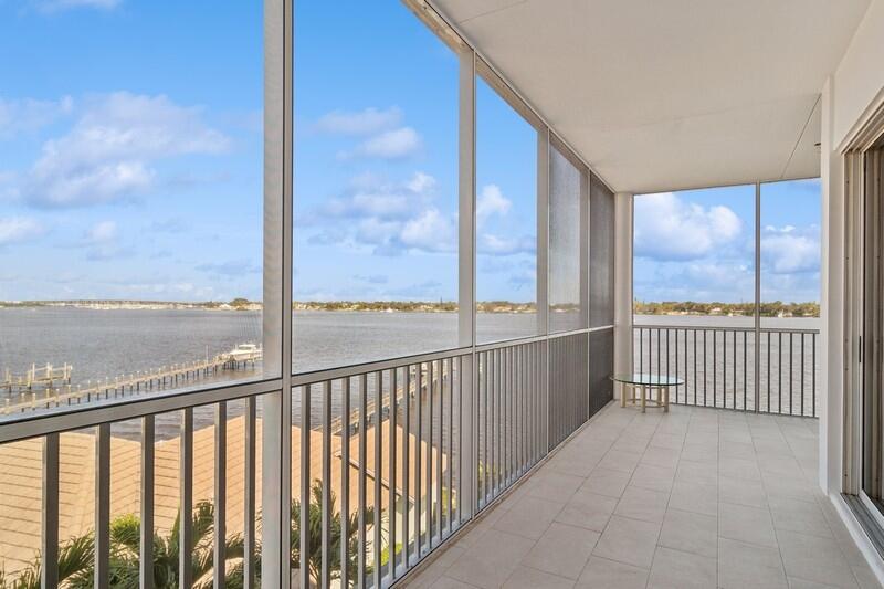 1130 Southwest Chapman Way, Unit 509 Palm City, FL 34990 - Photo 13 of 29 a view of a balcony with floor to ceiling window and wooden fence
