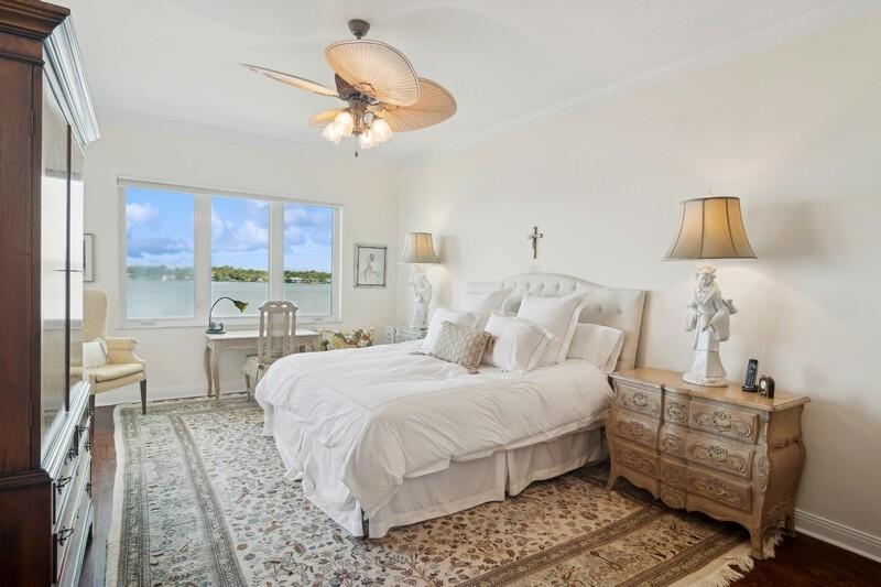 1130 Southwest Chapman Way, Unit 509 Palm City, FL 34990 - Photo 20 of 29 a bedroom with a bed and a chandelier