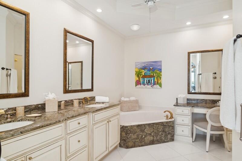 1130 Southwest Chapman Way, Unit 509 Palm City, FL 34990 - Photo 21 of 29 a spacious bathroom with a granite countertop double vanity sink a mirror and a bathtub