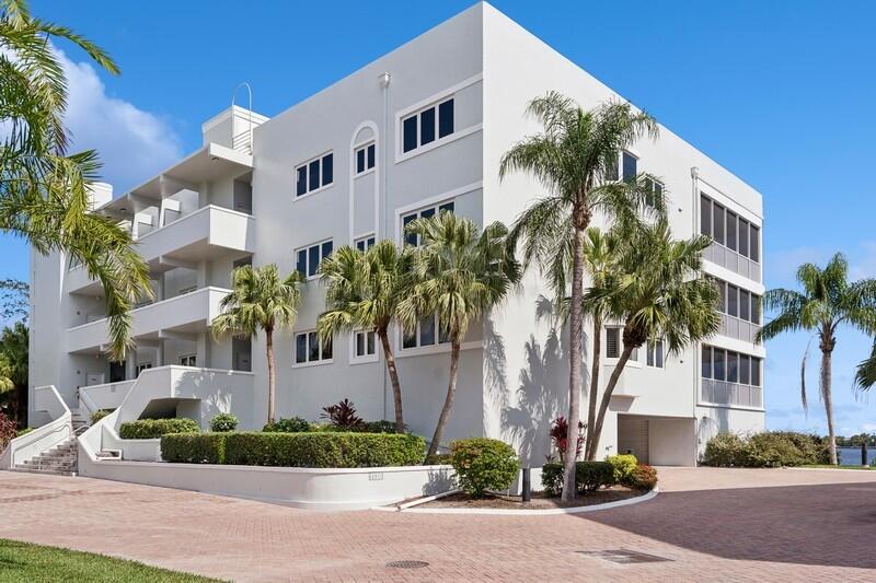 1130 Southwest Chapman Way, Unit 509 Palm City, FL 34990 - Photo 25 of 29 a front view of multiple houses with yard