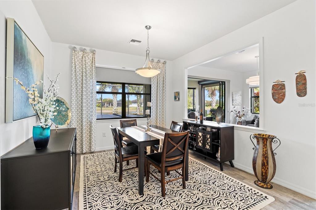 13856 RINUCCIO Street Venice, FL 34293 - Photo 15 of 63 a view of a dining room with furniture and chandelier