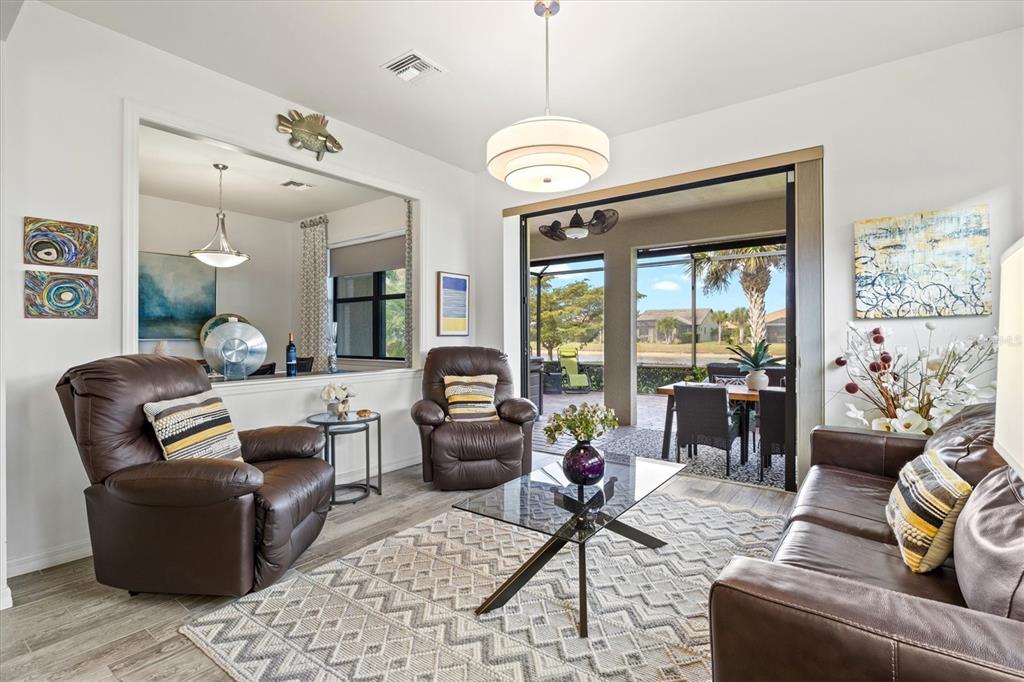 13856 RINUCCIO Street Venice, FL 34293 - Photo 18 of 63 a living room with patio furniture and a large window
