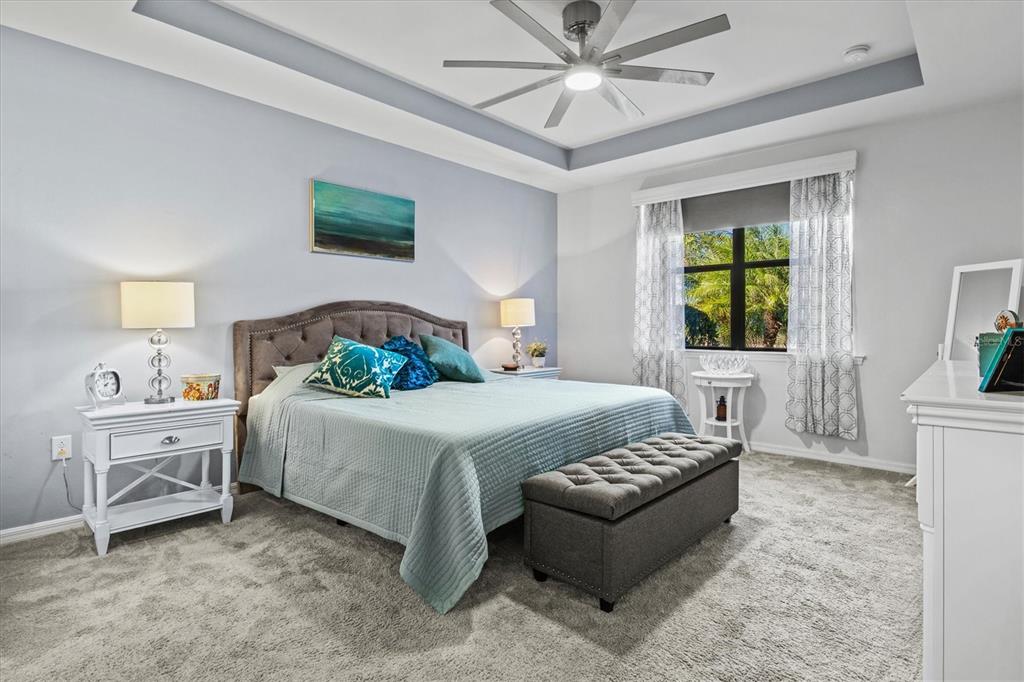 13856 RINUCCIO Street Venice, FL 34293 - Photo 21 of 63 a bedroom with a bed and a chandelier