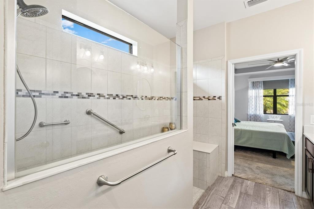 13856 RINUCCIO Street Venice, FL 34293 - Photo 24 of 63 a bathroom with a tub and shower