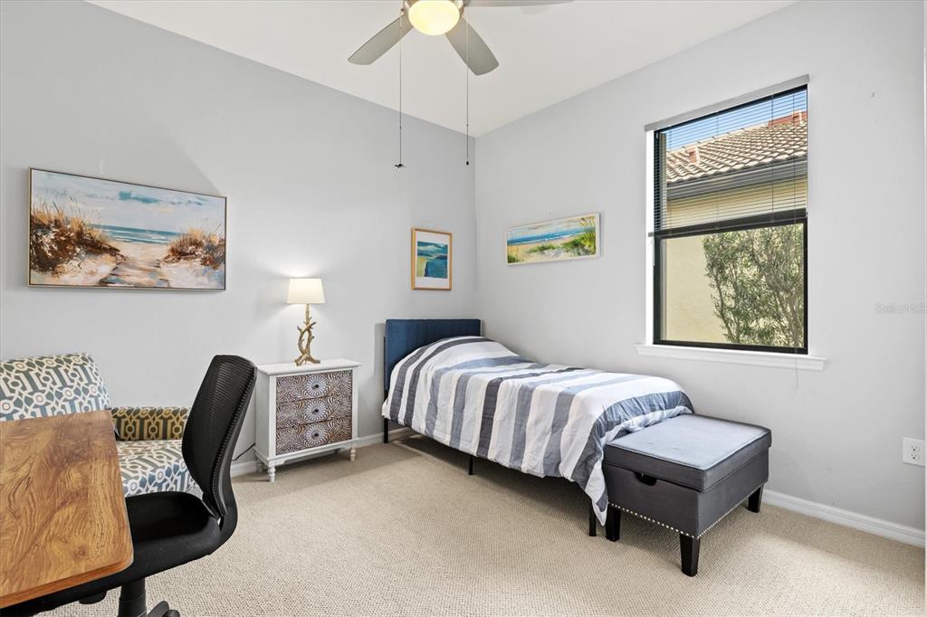 13856 RINUCCIO Street Venice, FL 34293 - Photo 26 of 63 a bedroom with a bed and a chair