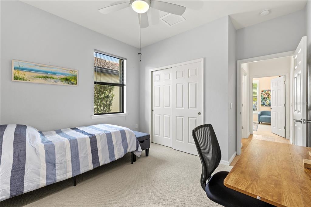 13856 RINUCCIO Street Venice, FL 34293 - Photo 27 of 63 a bed room with a bed chair and a window