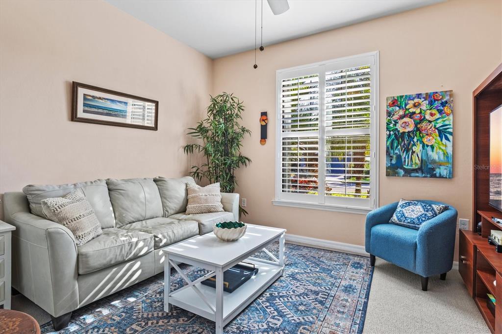 13856 RINUCCIO Street Venice, FL 34293 - Photo 29 of 63 a living room with furniture and a large window