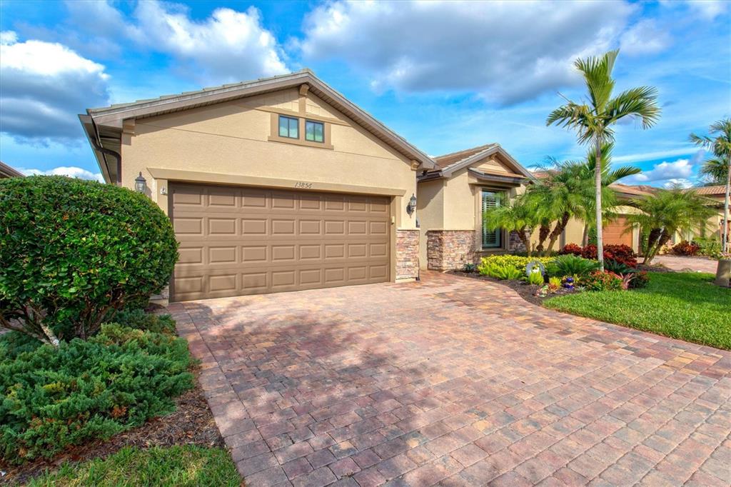 13856 RINUCCIO Street Venice, FL 34293 - Photo 3 of 63 a front view of a house with a yard and garage