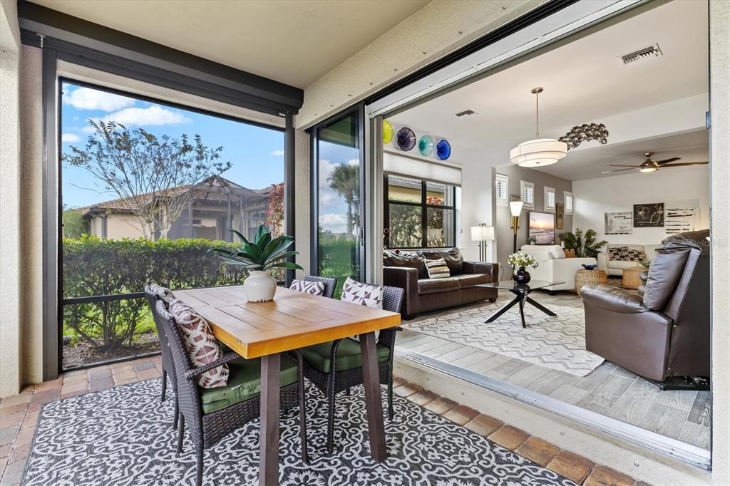 13856 RINUCCIO Street Venice, FL 34293 - Photo 34 of 63 a living room with furniture and a large window
