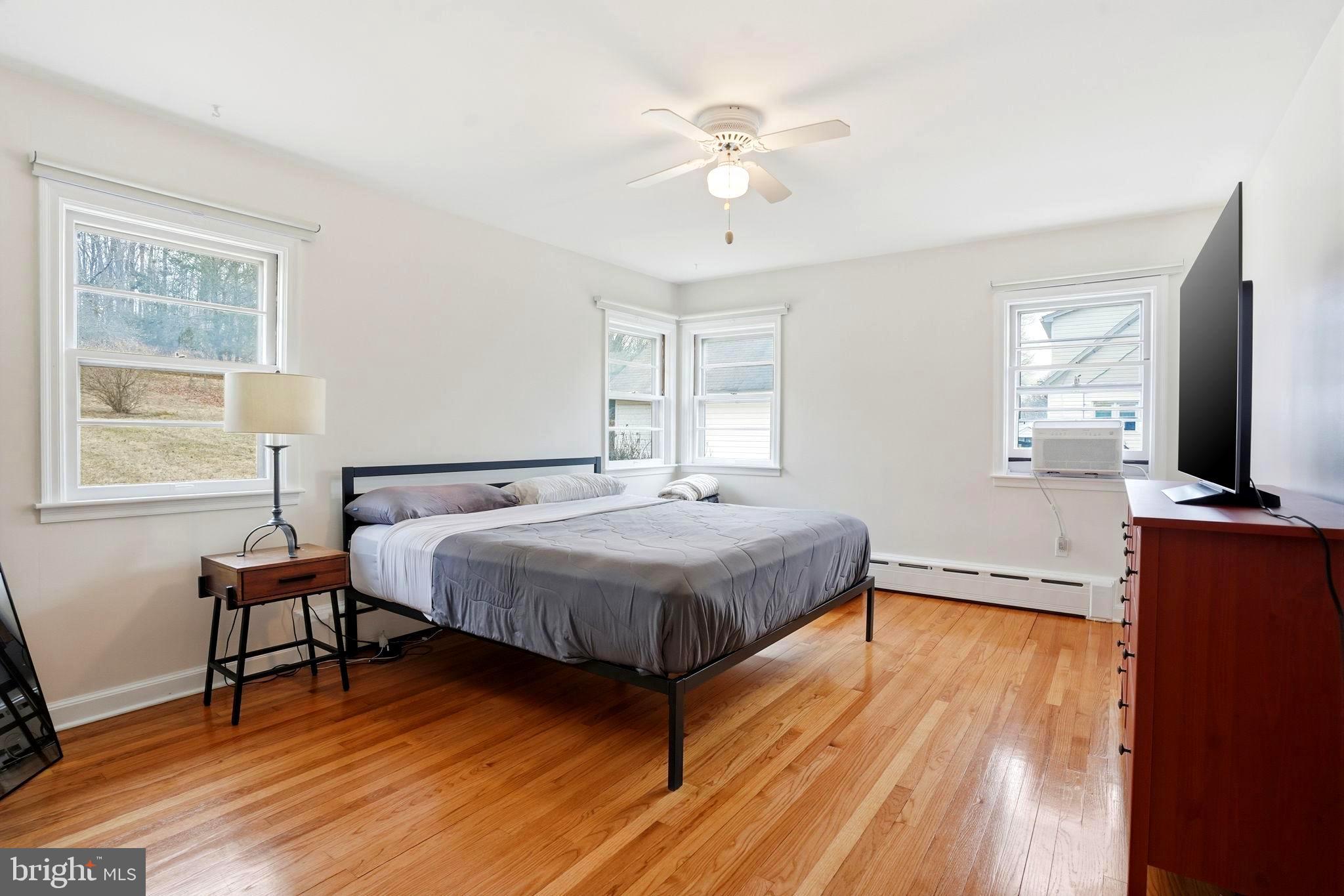 116 Green Street Green Lane, PA 18054 - Photo 13 of 38 a spacious bedroom with a bed and wooden floor
