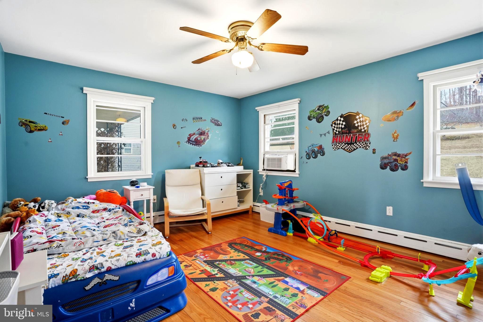 116 Green Street Green Lane, PA 18054 - Photo 16 of 38 a bedroom with a bed and a chandelier