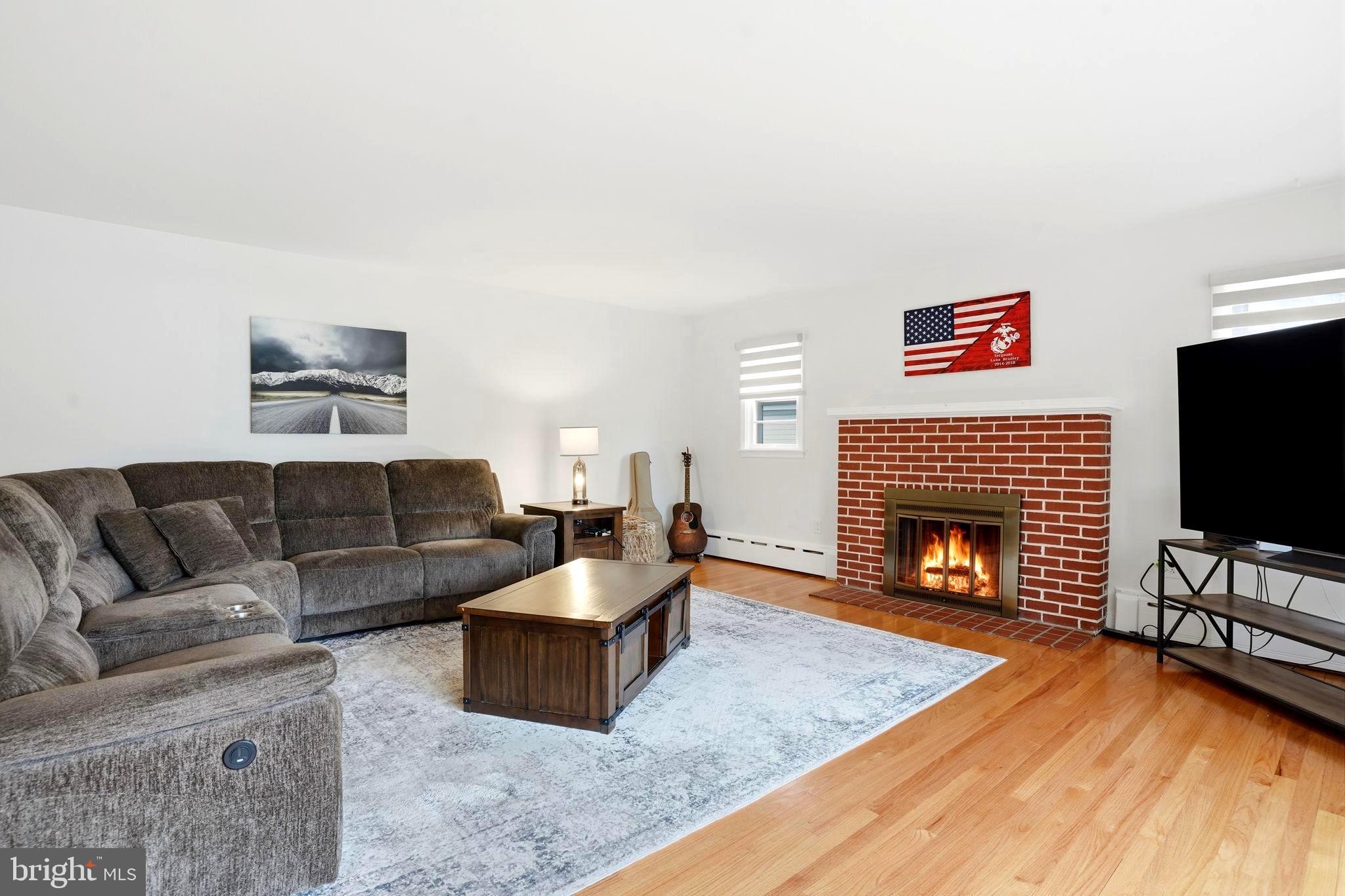 116 Green Street Green Lane, PA 18054 - Photo 6 of 38 a living room with furniture a flat screen tv and a fireplace