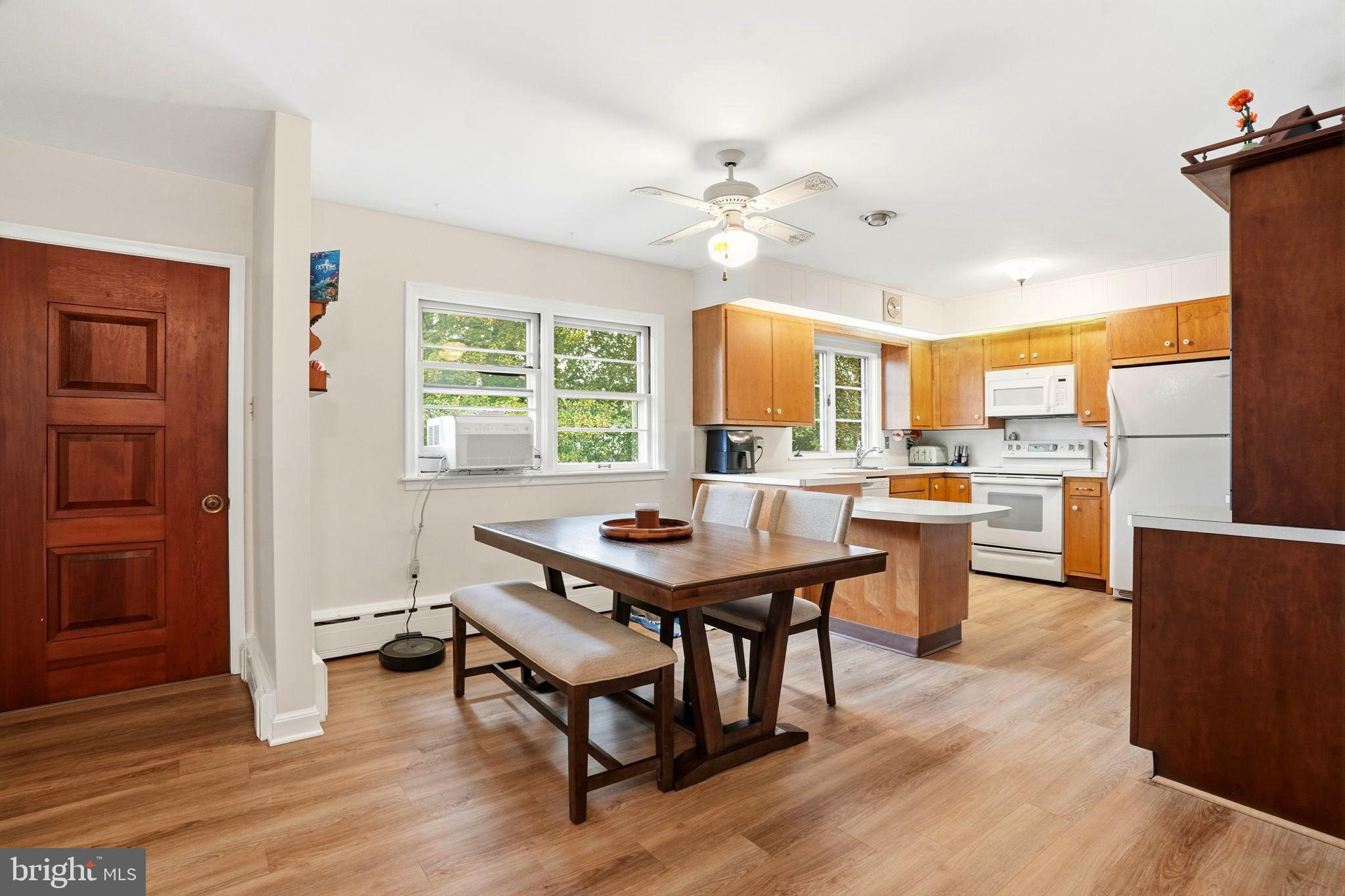 116 Green Street Green Lane, PA 18054 - Photo 8 of 38 a kitchen with a table chairs and wooden floor