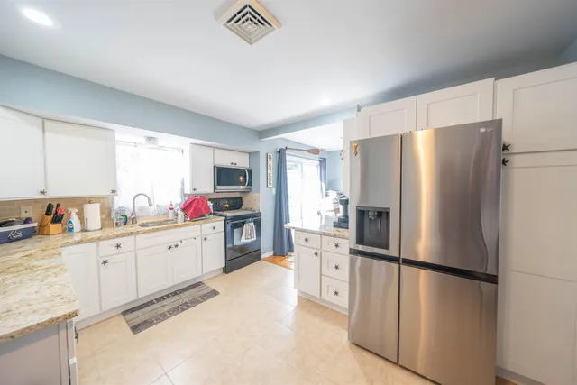 a kitchen with cabinets a refrigerator and a sink