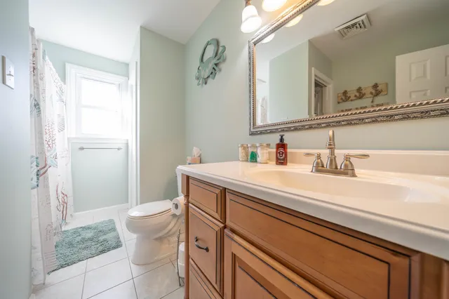 a bathroom with a sink a toilet and a mirror