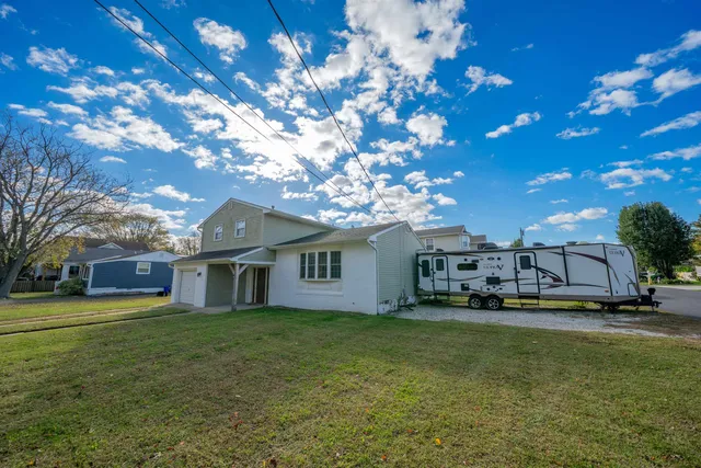 a house view with a sitting space and garden