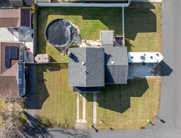an aerial view of residential house with outdoor space and swimming pool
