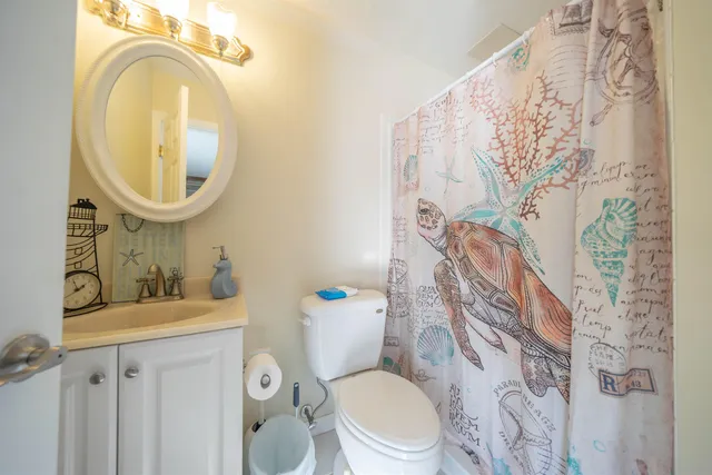 a white toilet sitting next to a bathroom sink
