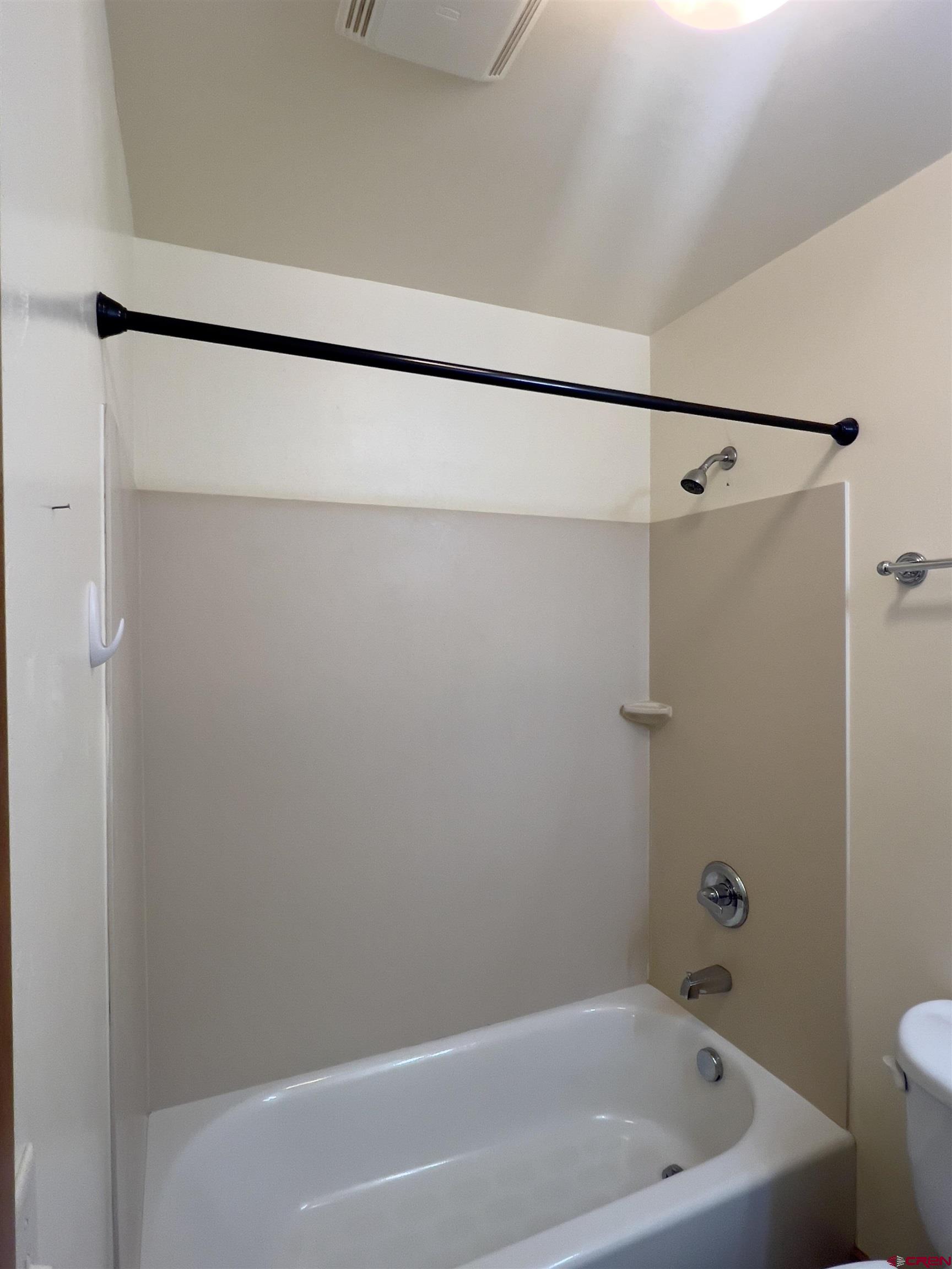 540 Redcliff Circle, Unit E 203 Ridgway, CO 81432 - Photo 24 of 36 a bathroom with a bathtub and a shower