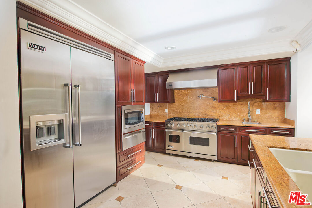 11753 Castillo Lane Porter Ranch, CA 91326 - Photo 13 of 44 a kitchen with stainless steel appliances granite countertop a refrigerator and a stove